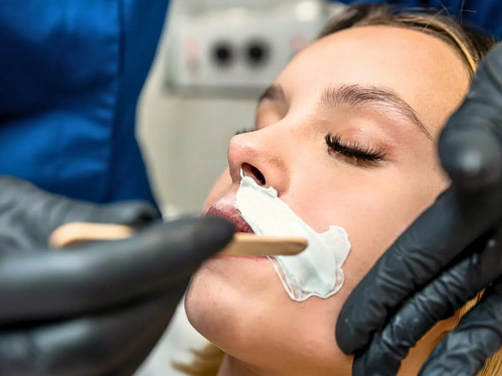 Woman getting upper lip waxed